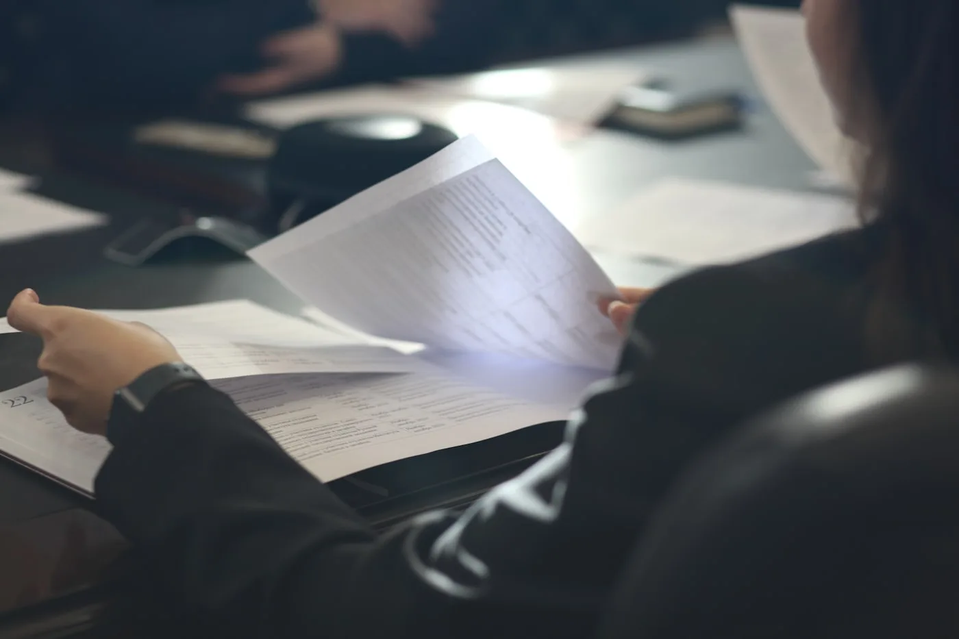 Hands holding an IEP document, reading closely
